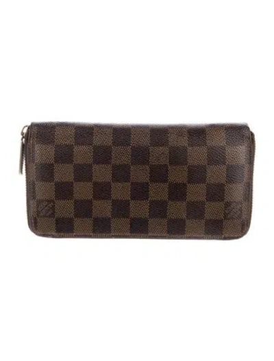 Pre-owned Louis Vuitton Damier Ebene Pattern Coated Canvas Zippy Wallet In Brown