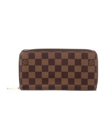Pre-owned Louis Vuitton Damier Ebene Pattern Coated Canvas Zippy Wallet In Brown