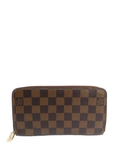 Pre-owned Louis Vuitton Damier Ebene Zippy Wallet In Brown