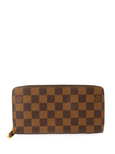 Pre-owned Louis Vuitton Zippy Damier Ebene Wallet In Brown