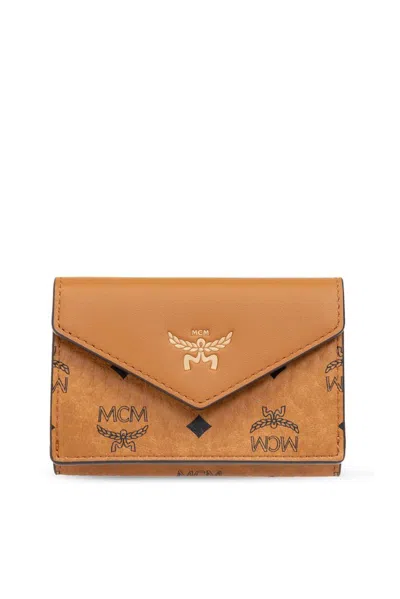 Mcm Logo Embossed Foldover Wallet In Brown
