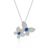 MEGAN WALFORD MEGAN WALFORD STERLING SILVER WHITE GOLD PLATED BLUE SAPPHIRE & CUBIC ZIRCONIA DOUBLE FLUTTERING BUT