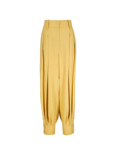 Michael Kors Pleated Button-cuff Trousers In Yellow
