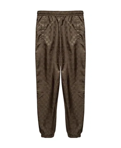 Misbhv Monogram Printed Tapered-leg Trackpants In Brown
