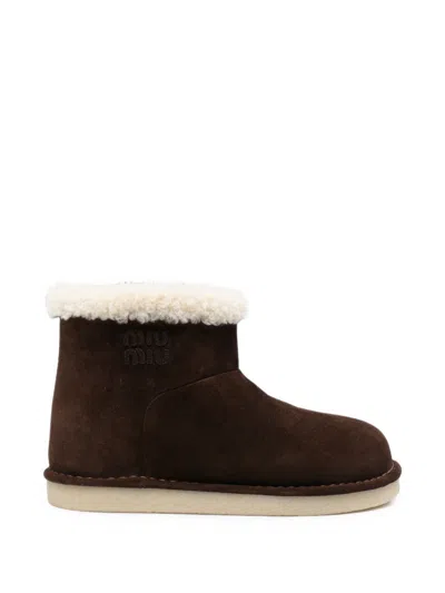 Miu Miu Boots With Embossed Logo In Brown