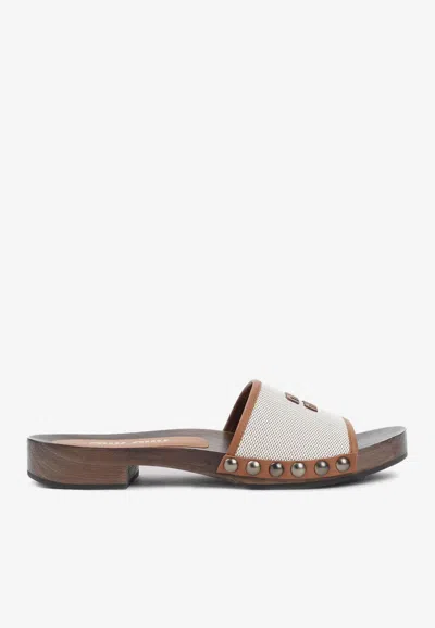 MIU MIU CANVAS AND LEATHER CLOGS