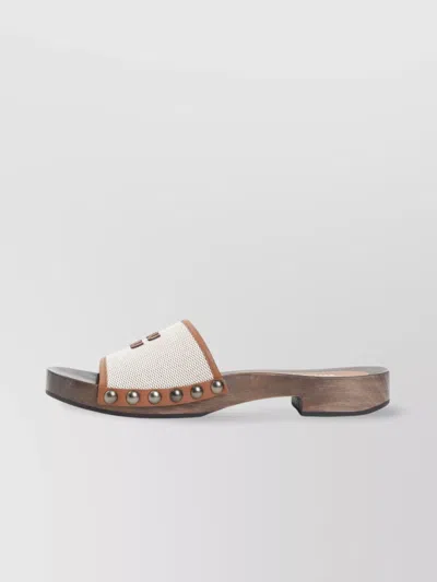 MIU MIU CANVAS AND LEATHER STUDDED CLOG SANDALS