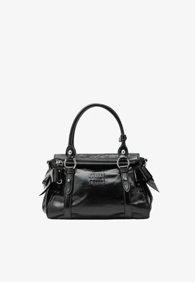 Miu Miu Embossed Logo Shiny Leather Top Handle Bag In Black