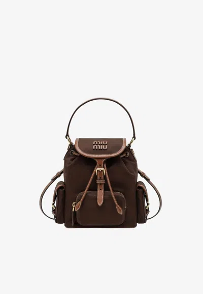 Miu Miu Logo Embossed Backpack In Brown