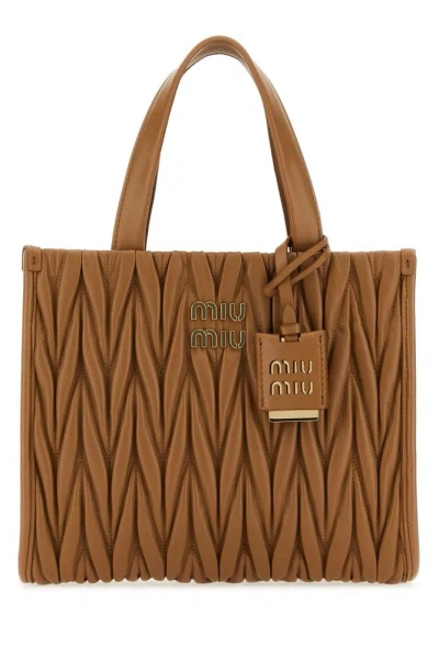 Miu Miu Matelassé Logo Plaque Tote Bag In Brown