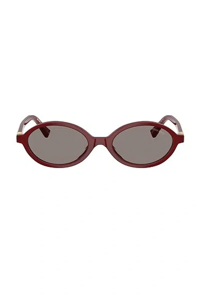 Miu Miu Oval Sunglasses In Red