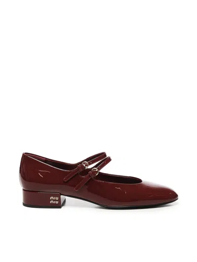 MIU MIU PATENT LEATHER PUMPS WITH BUCKLES