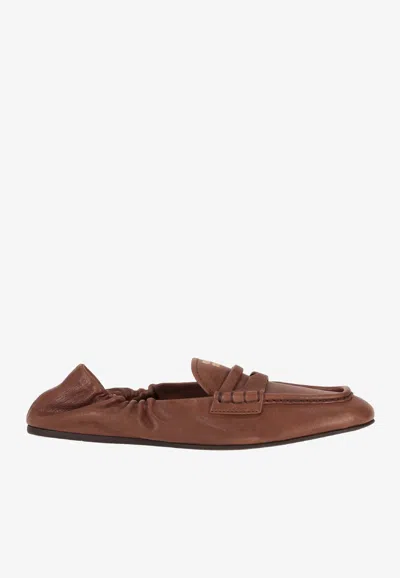 Miu Miu Embossed-logo Square Toe Loafers In Brown