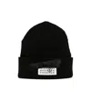 Mm6 Maison Margiela Mm6 By Maison Margiela Ribbed Black Knitted Beanie With Contrasting Logo Patch In Black