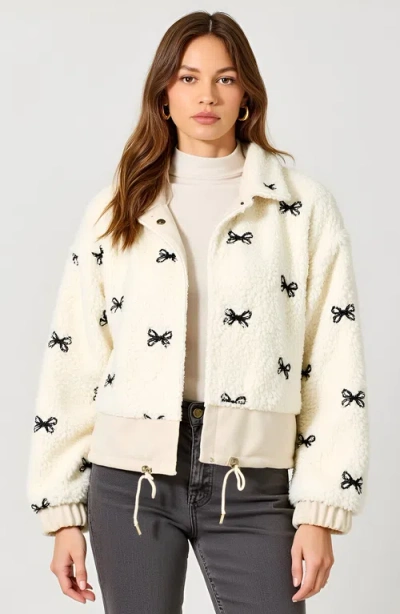 Modenaire Puff Sleeve Blouse With Velvet Bow Accents And Crew Neckline In Neutral