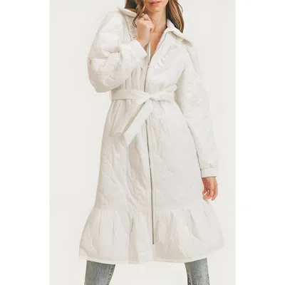 Modenaire Quilted Longline Coat With Ruffle Trim And Tie Waist Belt In White