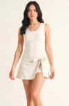 Modenaire Sleeveless Active Romper With Side Tie Skirt Overlay And Crew Neckline In White