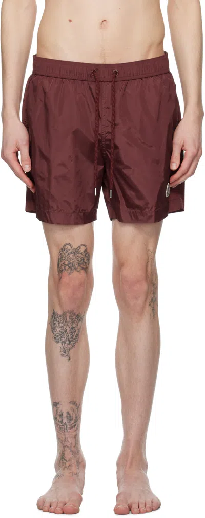 MONCLER BURGUNDY LOGO PATCH SWIM SHORTS