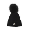 Moncler Ribbed Knit Wool Beanie With Faux Fur Pom-pom In Black