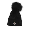 Moncler Ribbed Knit Wool Beanie With Faux Fur Pom-pom In Black