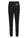 Moschino All-over Print Trousers In Black