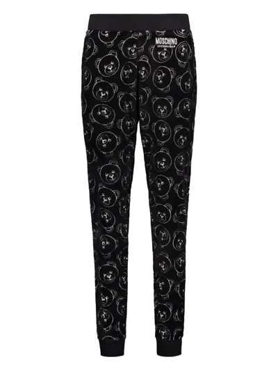 Moschino All-over Print Trousers In Black