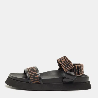 Pre-owned Moschino Brown/black Canvas Logo Ankle Strap Flat Sandals Size 37
