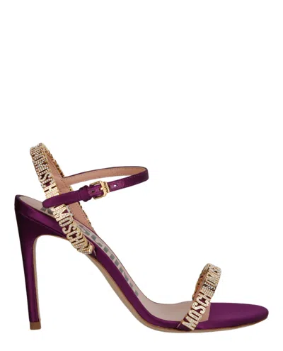 Moschino Crystal Embellished Logo Satin Heel Sandals In Purple