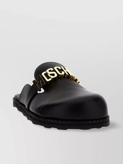 Moschino Flat Sole Open Back Sandals In Black