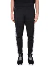 Moschino Jogging Pants With Adjustable Drawstring And Zippered Pockets In Black