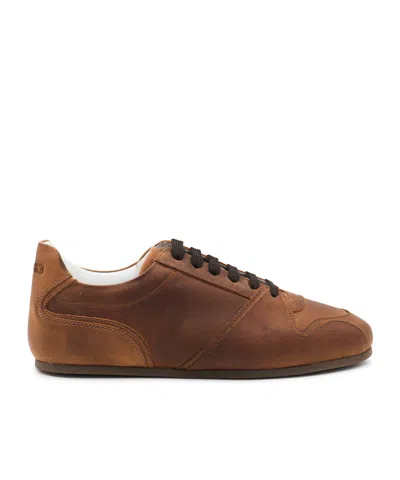 Moschino Logo Embossed Sneakers In Brown