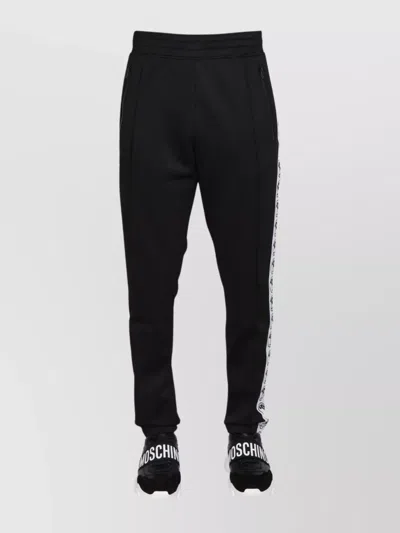 MOSCHINO SPORTY TROUSERS WITH ELASTIC WAISTBAND AND SIDE STRIPE