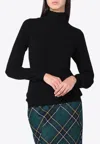 Moschino Turtleneck Sweater Featuring Crossed Back Tie In Black