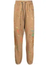 Mostly Heard Rarely Seen Warped Paint-embroidered Track Pants In Brown