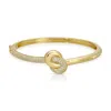 Native Gem Women's Gold Love Knot Bangle Bracelet In Gold