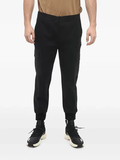 Neil Barrett Low-rise Skinny-fit Tapered Trousers In Black