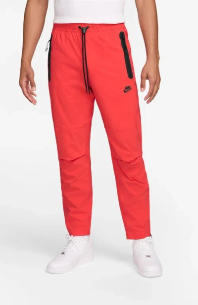 Nike Dri-fit Tech Woven Pants In Light Crimson/black