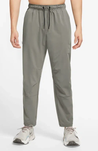 Nike Dri-fit Unlimited Drawstring Pants In Gold