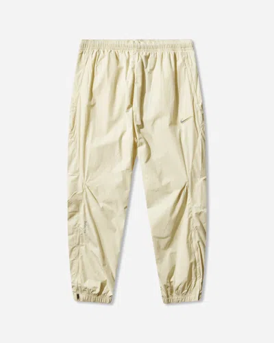 Nike Men S Nocta Woven Track Pants Alabaster In Yellow