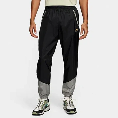 Nike Men's Windrunner Woven Lined Pants In Black/dark Stucco/saturn Gold
