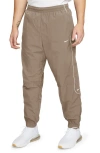 Nike Solo Swoosh Water Repellent Track Pants In Khaki/white