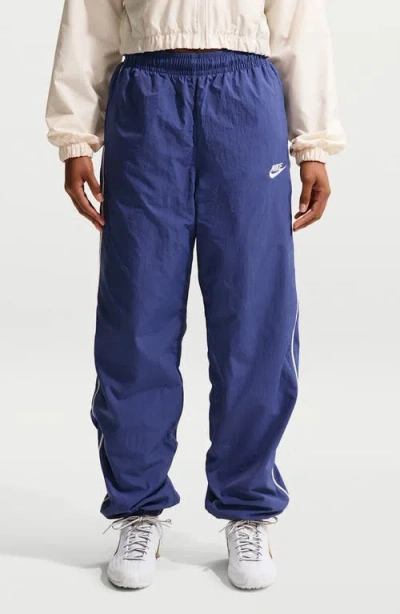 Nike Sportswear Windrunner Water Repellent Track Pants In Blue