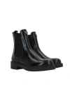 Prada Logo Plaque Brushed-effect Ankle Boots In Black