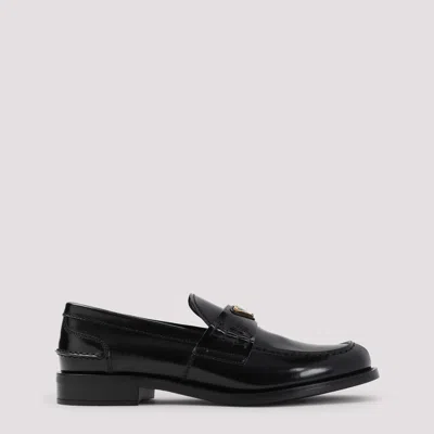 Prada Leather Loafers With Decorative Buckle And Round Toe In Black