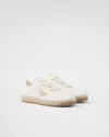 Prada Streamlined Leather Low-top Sneakers With Metallic Accent In Ivory