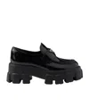 Prada Monolith Lacquered Leather Loafers In Black