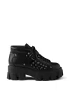 Prada Monolith Studded Leather Booties In Black