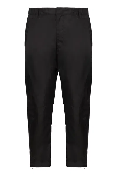 Prada Logo Plaque Tapered Pants In Black