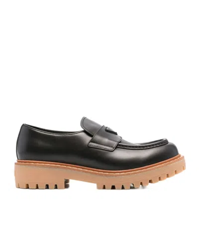 Prada Logo Plaque Round Toe Loafers In Black