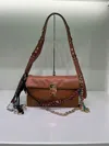 Prada Small Leather Shoulder Bag With Ornaments In Brown